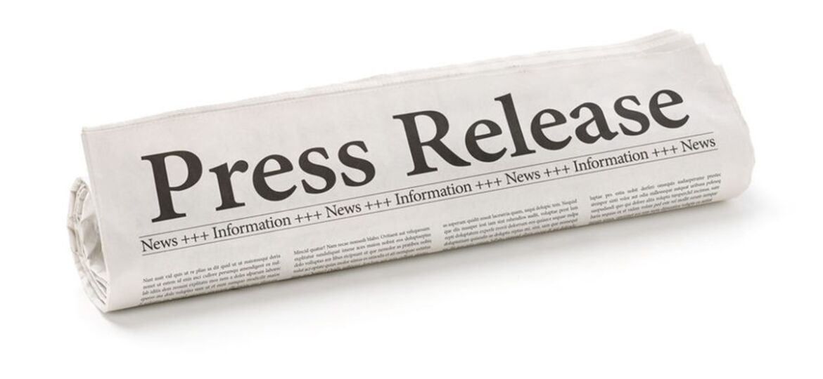 Rolled newspaper with the headline Press Release